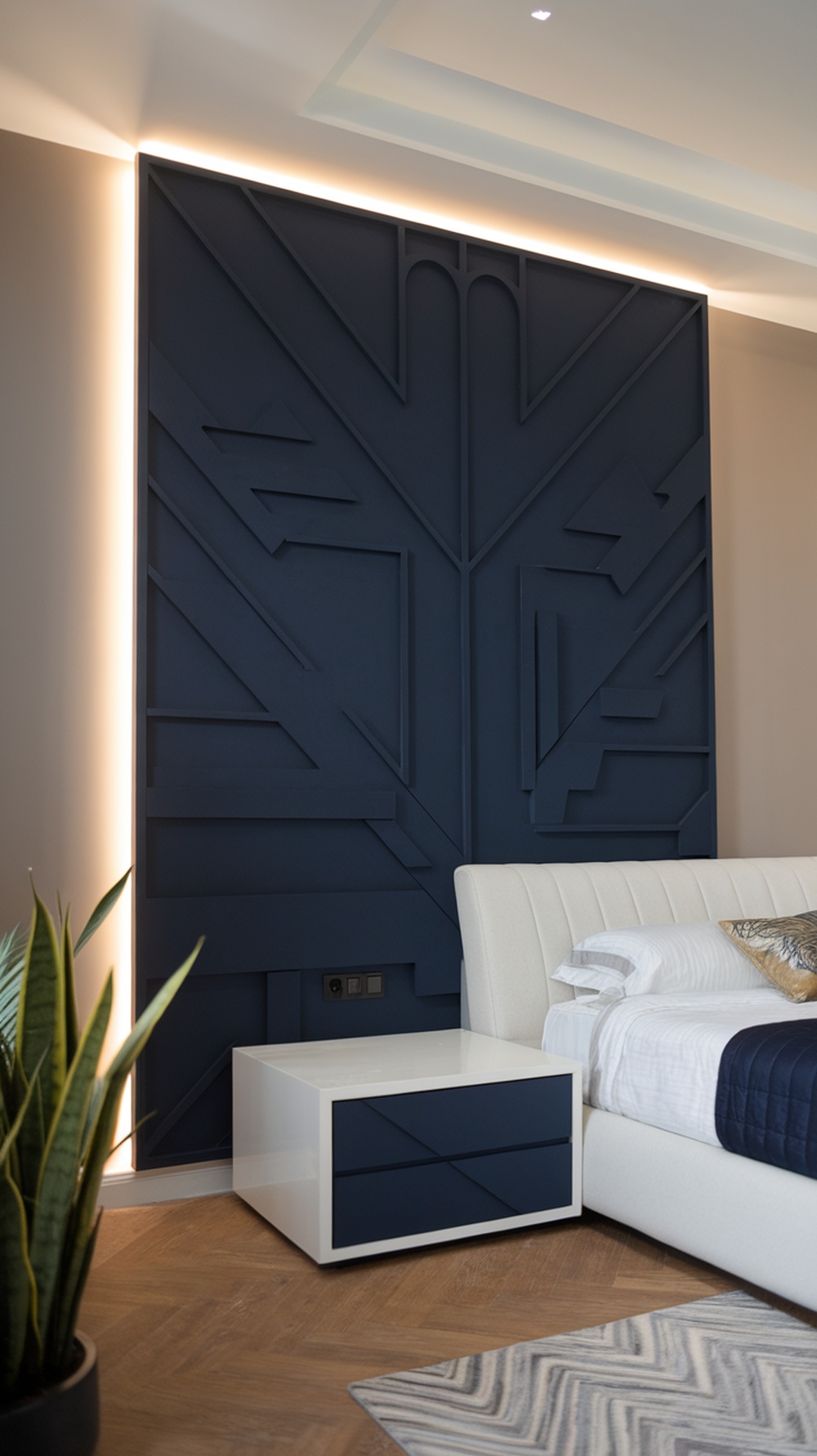 A modern bedroom featuring a navy blue wall with a geometric design, a white bed, and a nightstand.