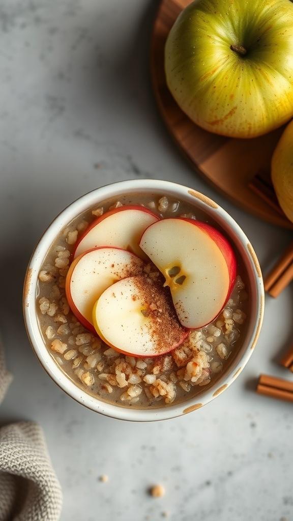A bowl of apple cinnamon quinoa porridge topped with apple slices and cinnamon, with green apples in the background.