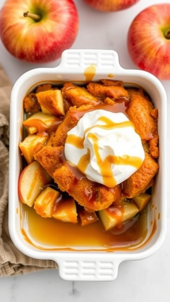 A dish of caramel apple bread pudding topped with whipped cream and caramel sauce, surrounded by fresh apples.
