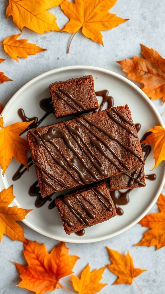 Chocolate pumpkin brownies drizzled with chocolate sauce, surrounded by autumn leaves.