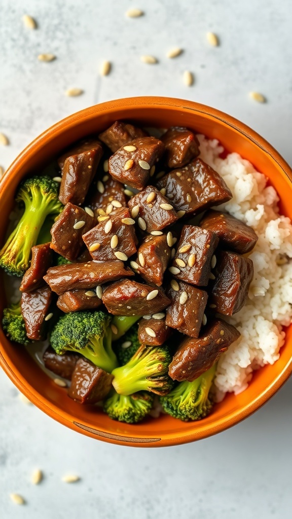 A bowl of teriyaki beef with broccoli and rice, topped with sesame seeds.