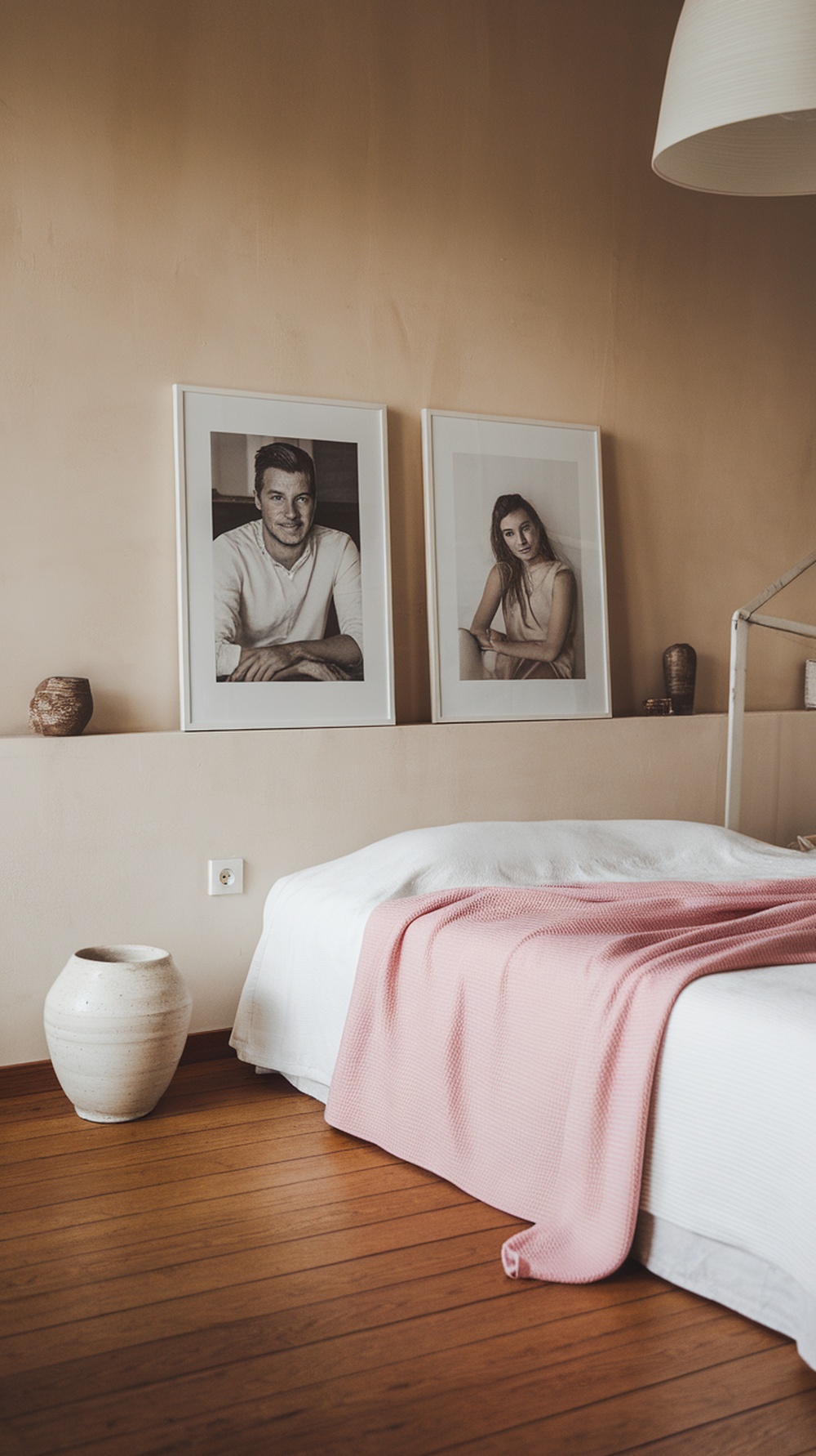 Minimalist bedroom with framed photos and a cozy blanket