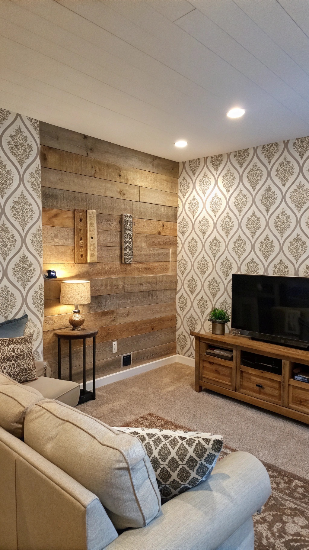 Cozy living room with textured wall treatments featuring wood and patterned wallpaper.