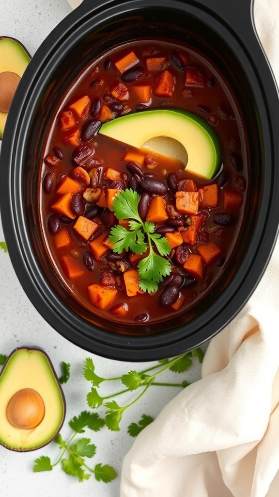 A bowl of sweet potato and black bean chili with avocado and cilantro