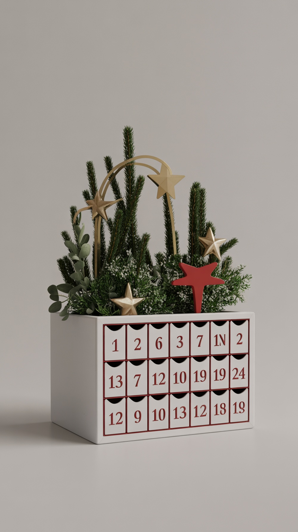 A decorative advent calendar planter with small drawers, greenery, and festive stars.