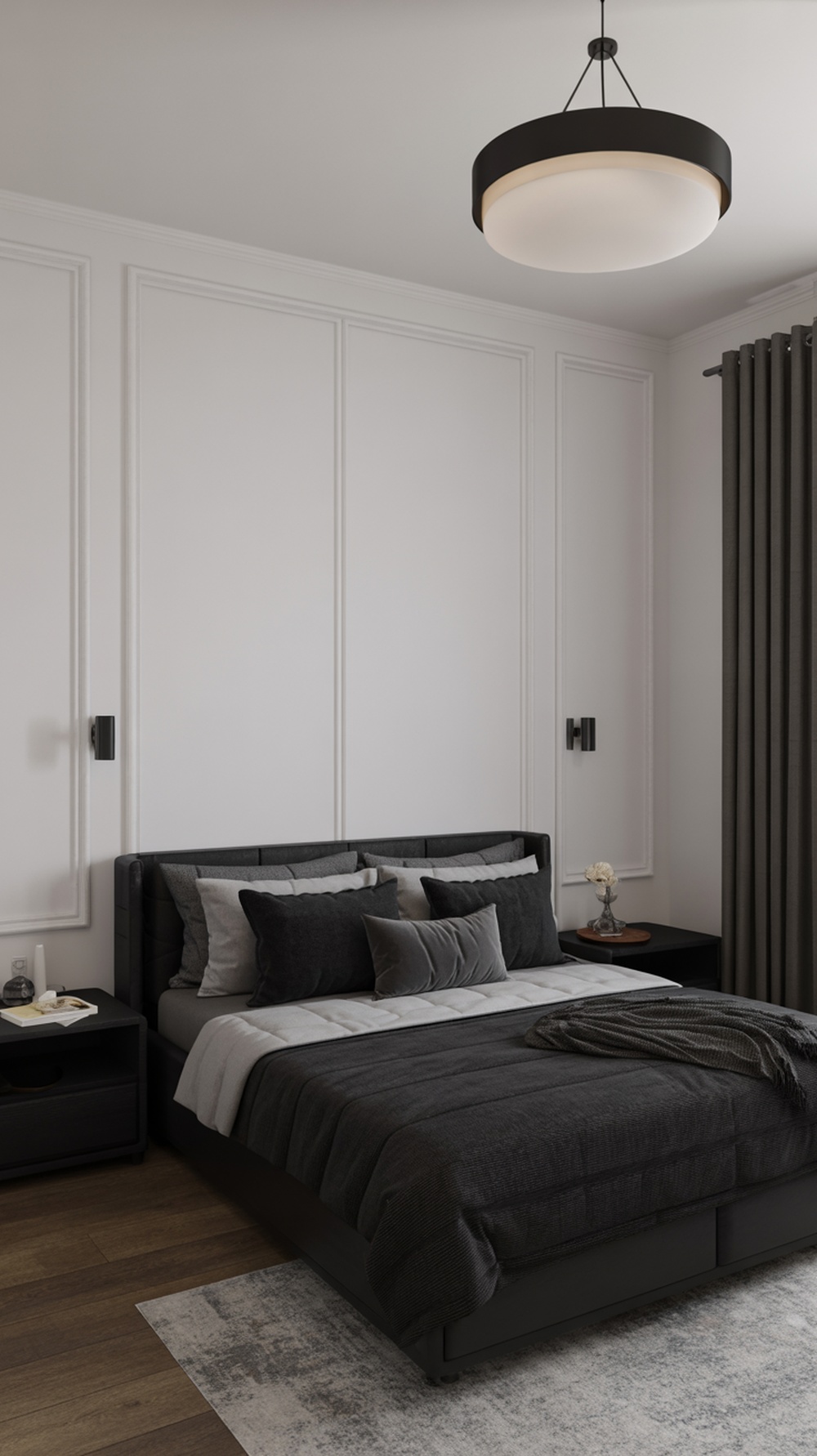 A modern black and white bedroom featuring a black bed frame, gray pillows, and a round black pendant light.