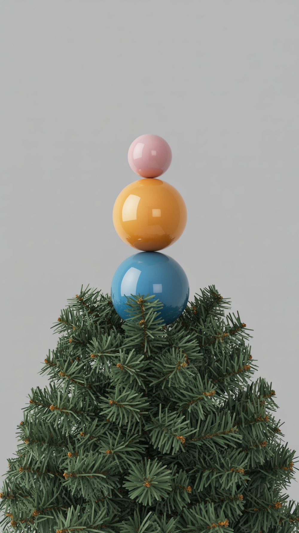 A Christmas tree topped with three colorful baubles: pink, orange, and blue.