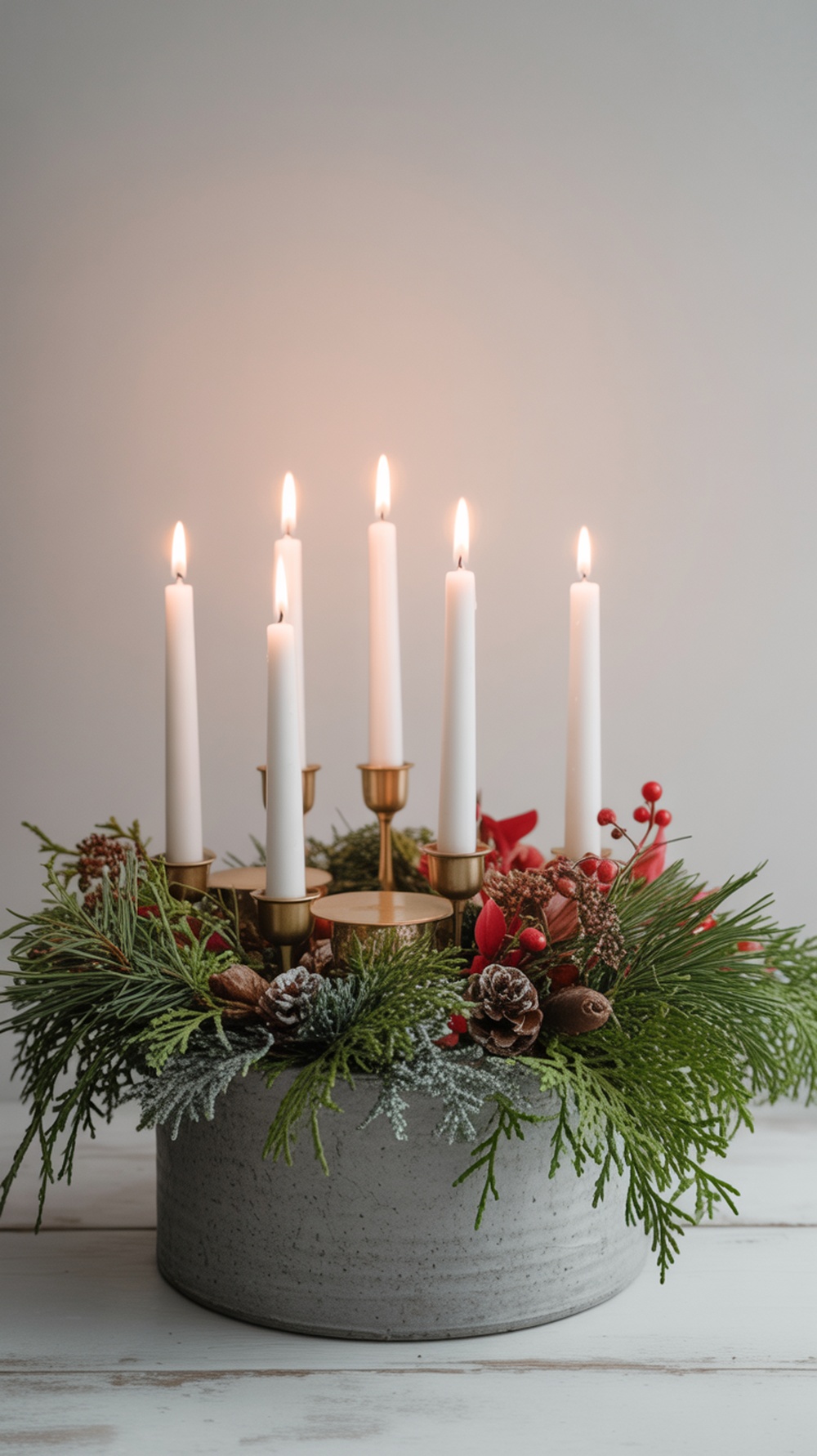 A winter planter centerpiece with candles, pinecones, and greenery.
