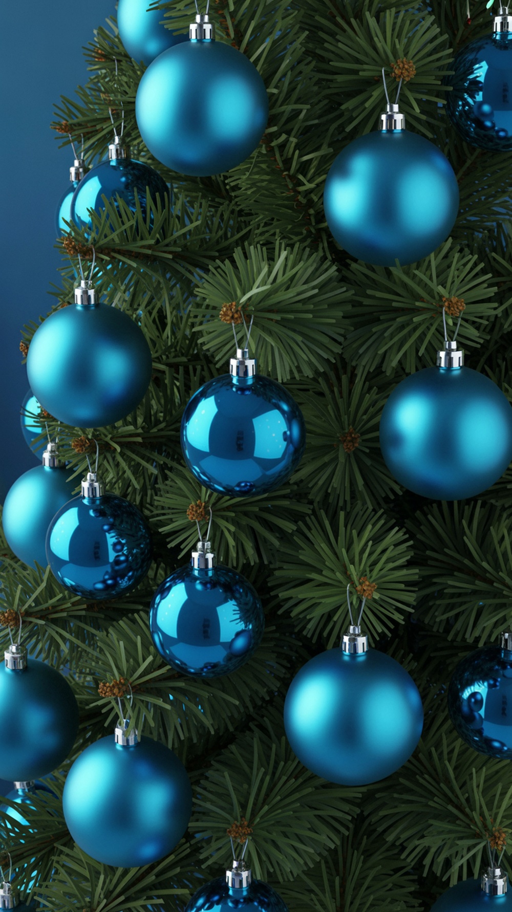 Close-up of cerulean blue baubles hanging on a Christmas tree.