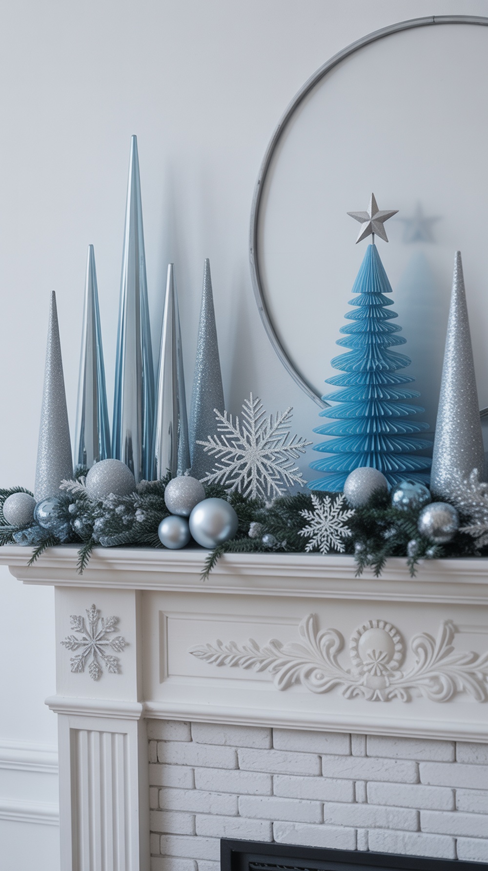 A beautifully decorated mantel featuring frosty blue and silver Christmas decor, including a blue tree, silver ornaments, and snowflake accents.