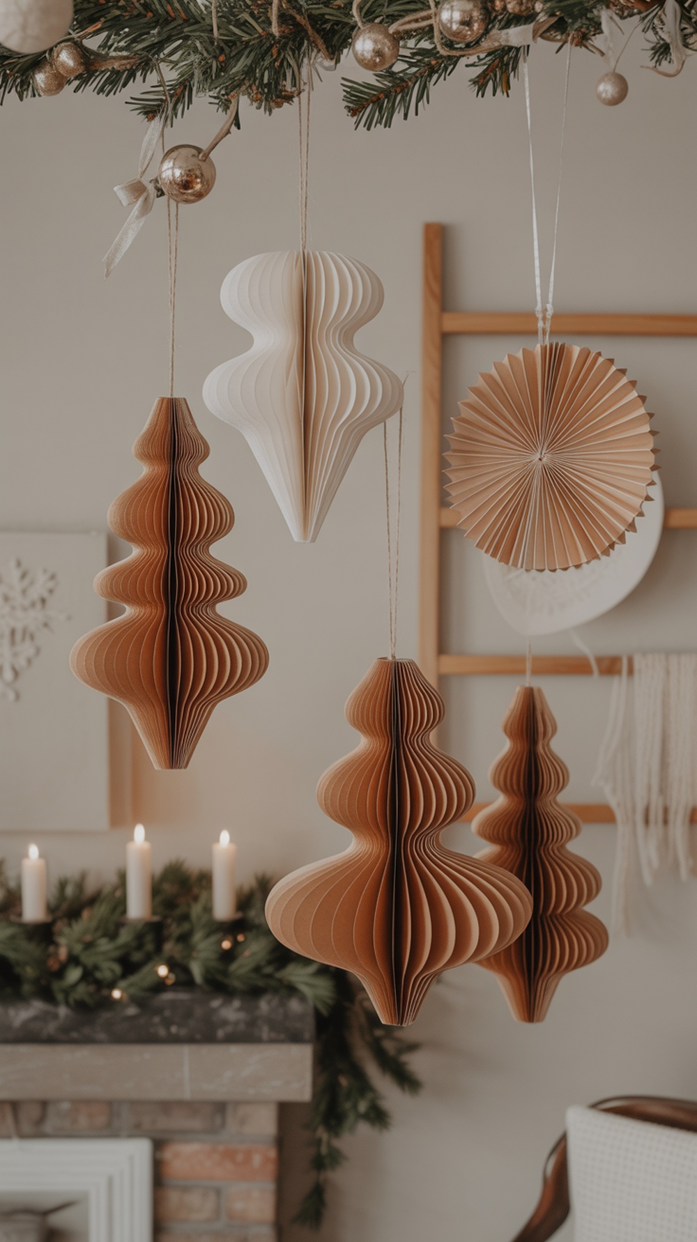 Handmade paper decorations in neutral tones hanging from a garland, creating a cozy Christmas atmosphere.