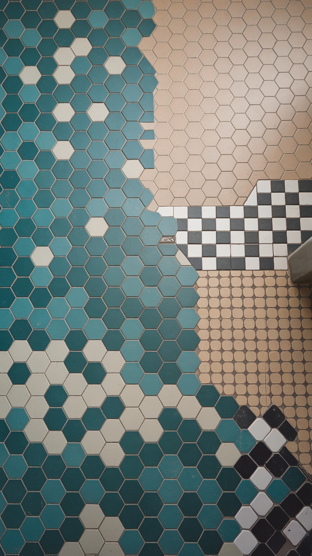 15 Small Funky Bathroom Ideas to Transform Your Space Instantly A creative tile pattern featuring hexagonal tiles in teal and beige, alongside a checkerboard design.