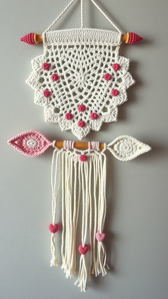 A crochet wall hanging featuring a heart motif and an arrow design, in white and pink colors.