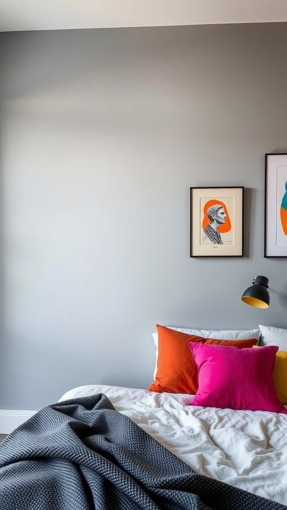 A grey bedroom featuring colorful pillows in orange and pink, with modern artwork on the wall.