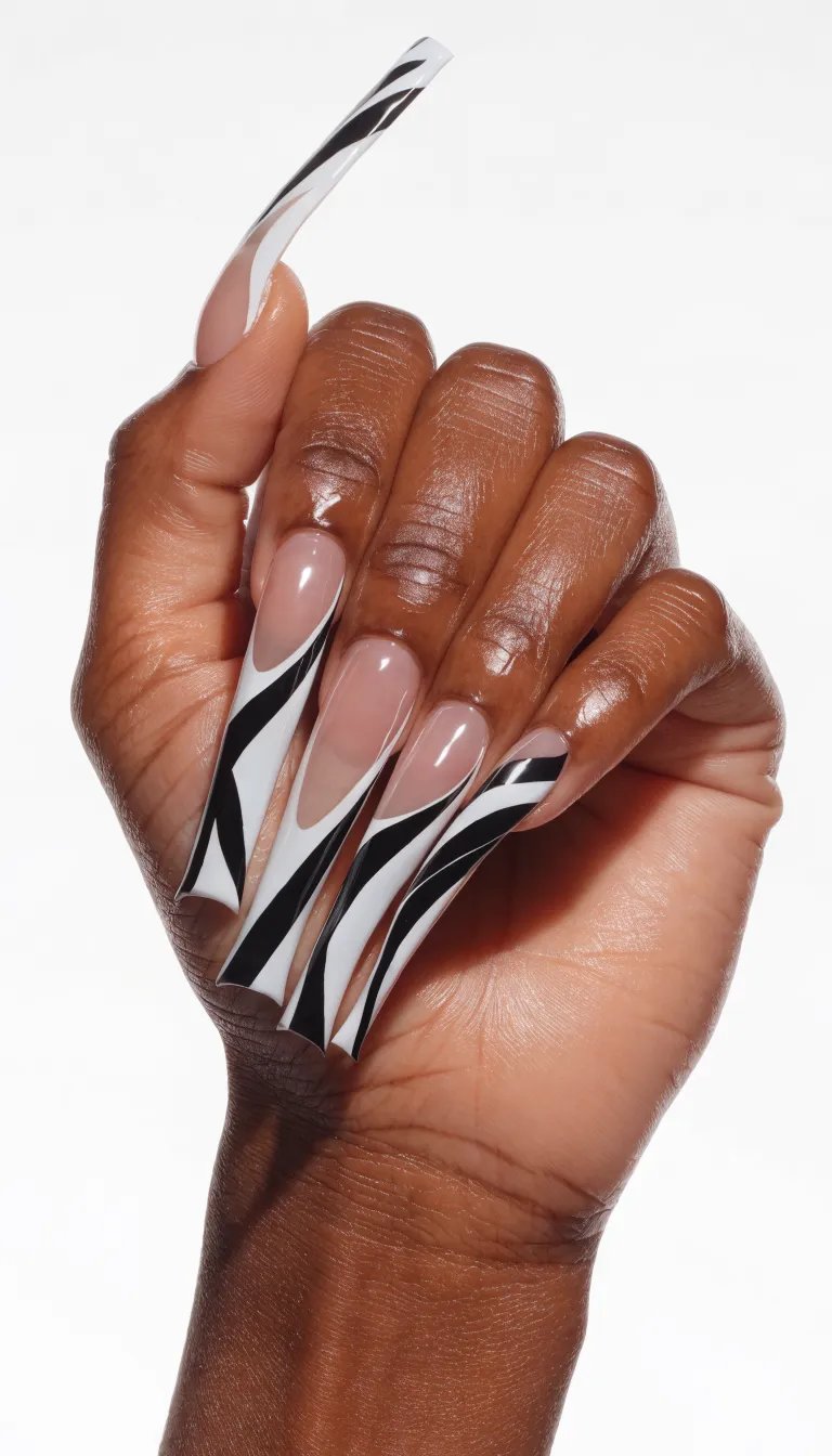 10 Stunning French Tip Nail Designs You Need to Try 8 Close-up of hands with long nails featuring geometric French tip designs in black and white.