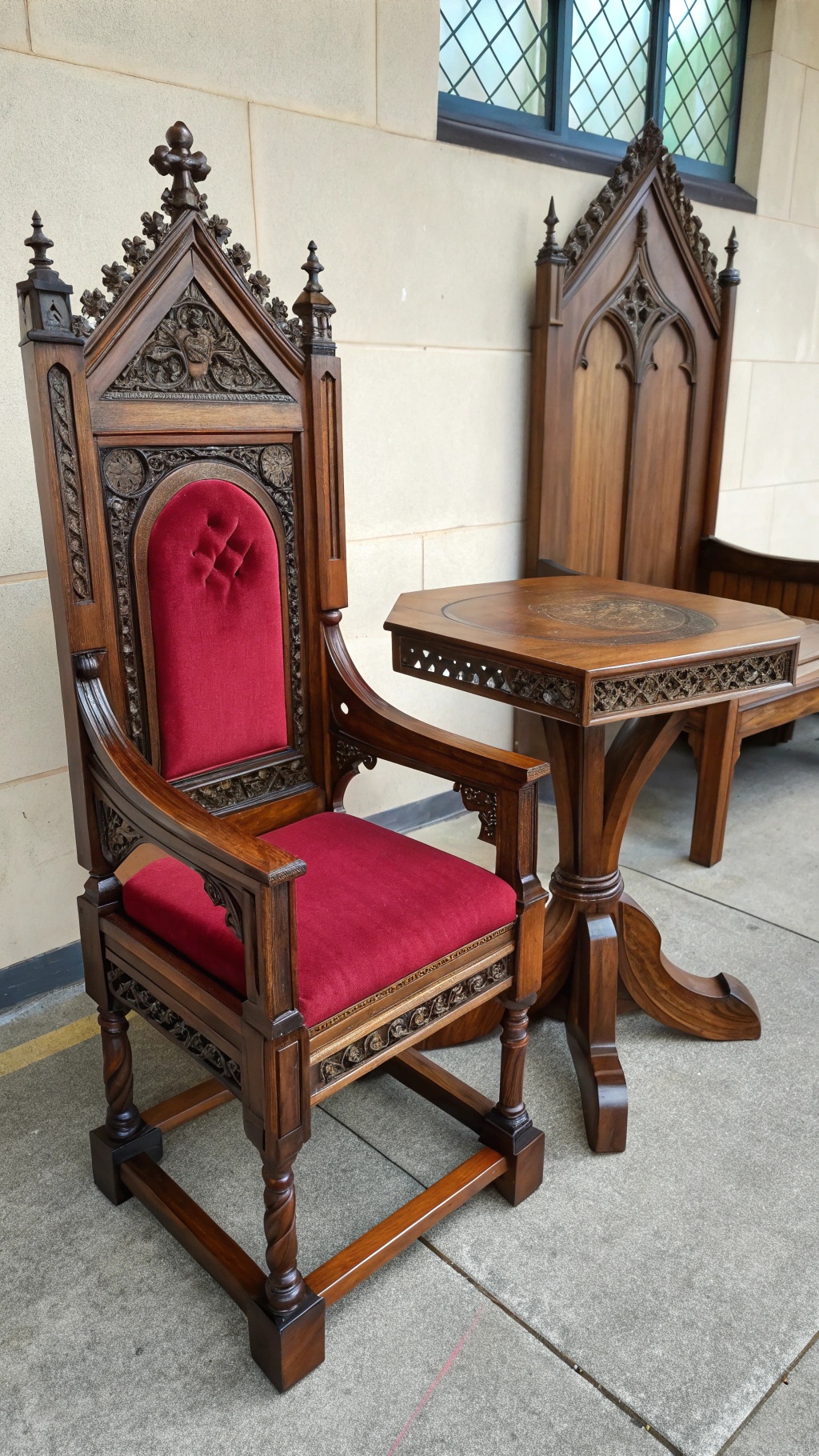 Whimsical Goth Room Decor: Crafting a Magical, Moody Sanctuary A gothic wooden chair with red upholstery and an intricately carved table.