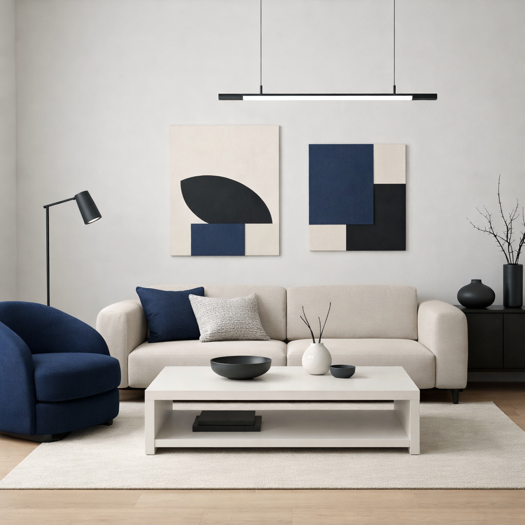 A minimalist living room featuring navy blue furniture and geometric art.