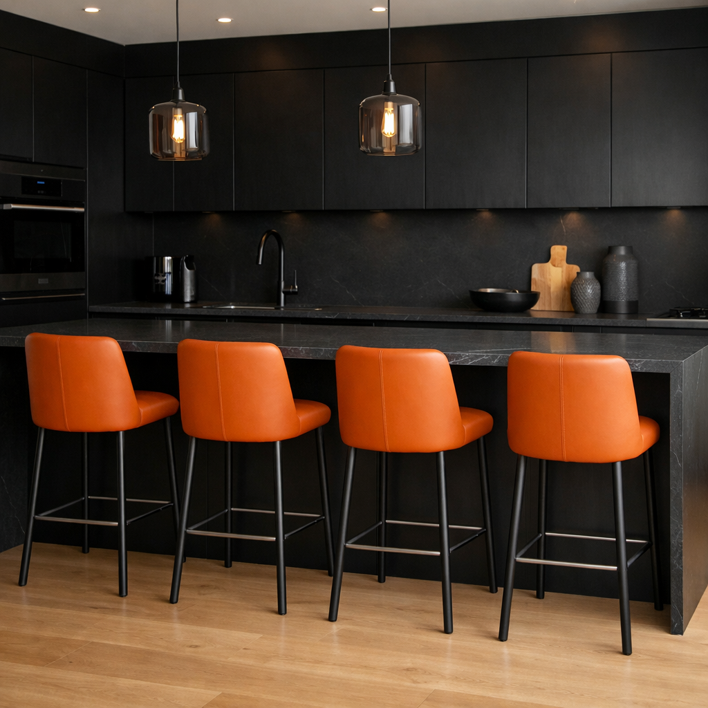 Contemporary kitchen featuring orange bar stools against a black backdrop.