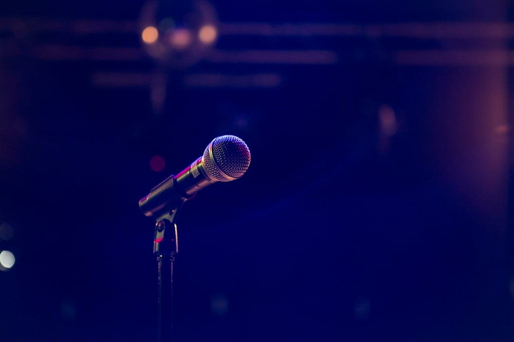 stand-up microphone on empty stage; illustrative