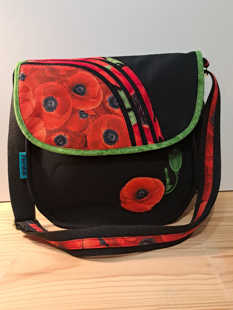 Poppy flowers on black shoulder bag 
