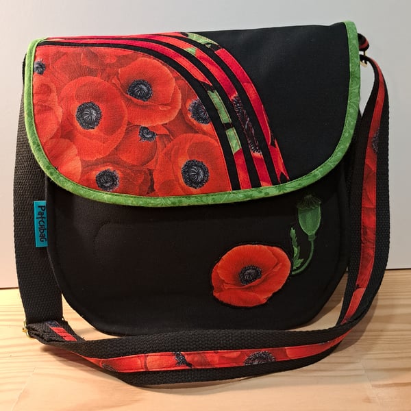 Poppy flowers on black shoulder bag 