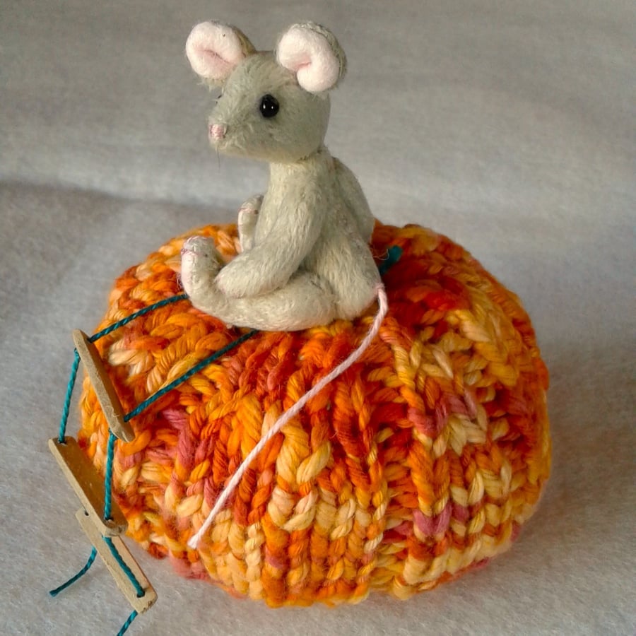 Dora, a tiny jointed mouse sitting on a pumpkin