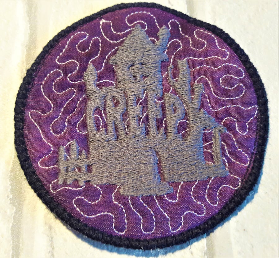 Halloween themed coaster with haunted house design