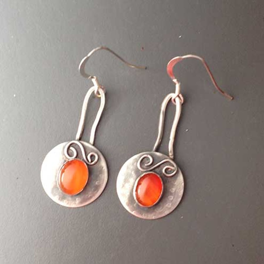 Silver and orange dangle shield earrings
