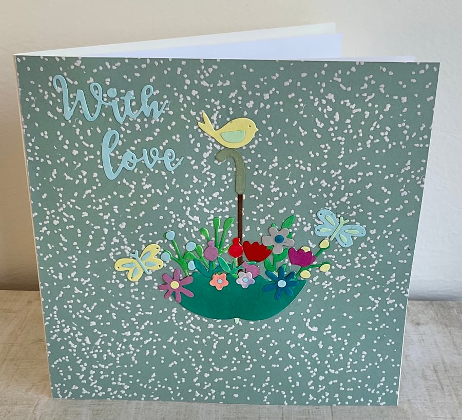 Card. Flowers in an umbrella greetings card for her birthday or other occasion. 