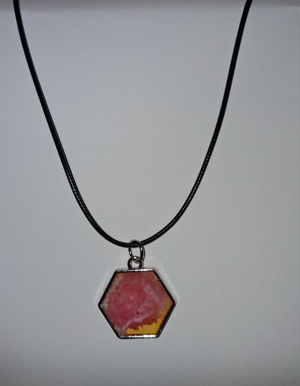 Handmade pink and yellow pendant on black waxed cord