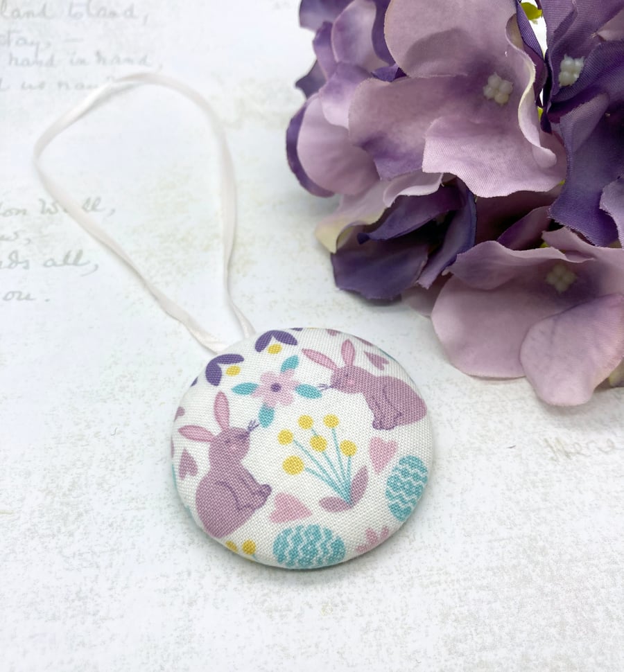 Spring rabbits surrounded by flowers and hearts fabric button ornament