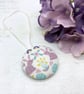 Spring rabbits surrounded by flowers and hearts fabric button ornament
