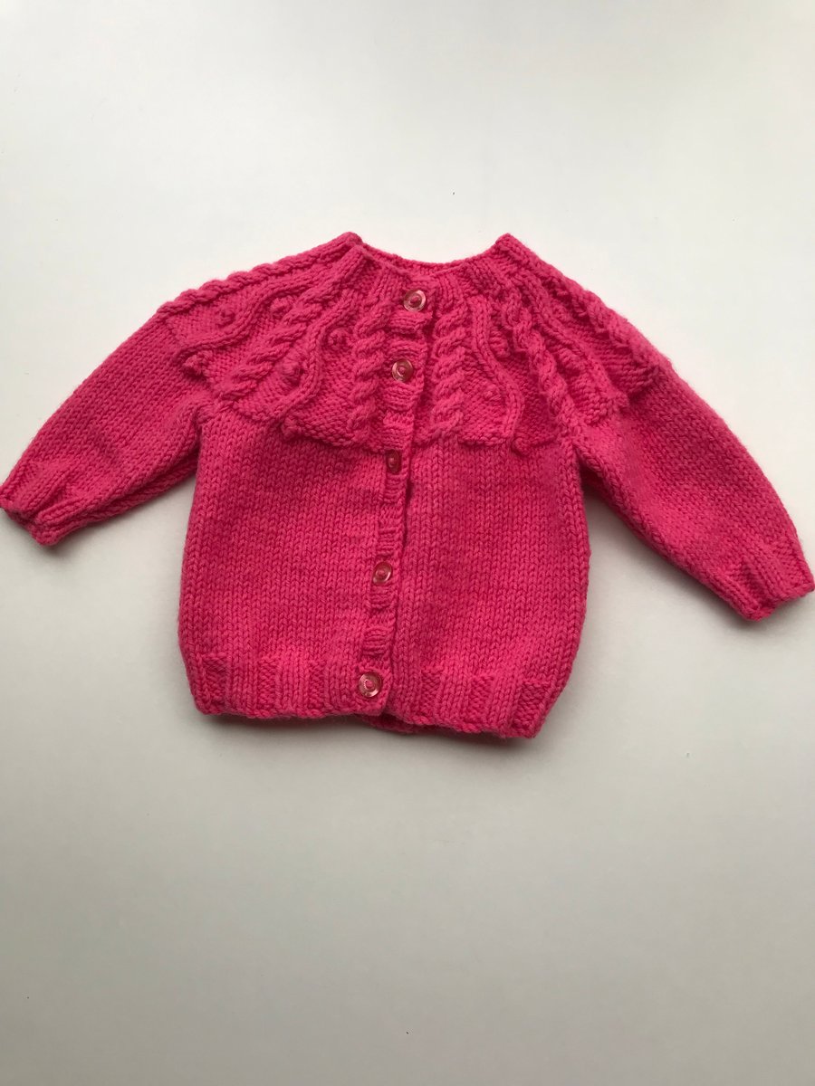 Bright pink cardigan with patterned yolk