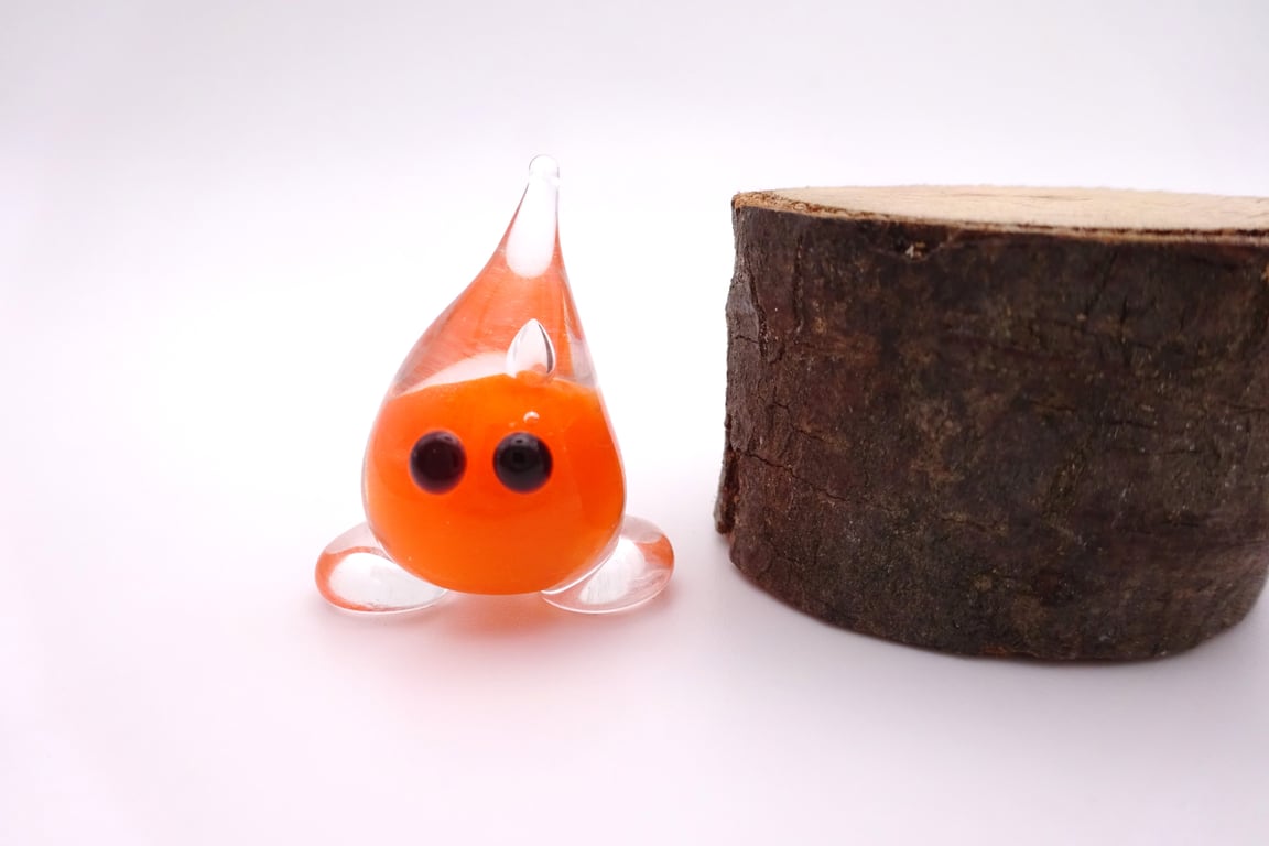 small orange glass wisp figure