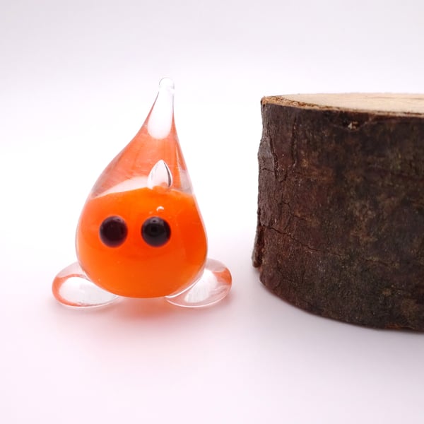 small orange glass wisp figure
