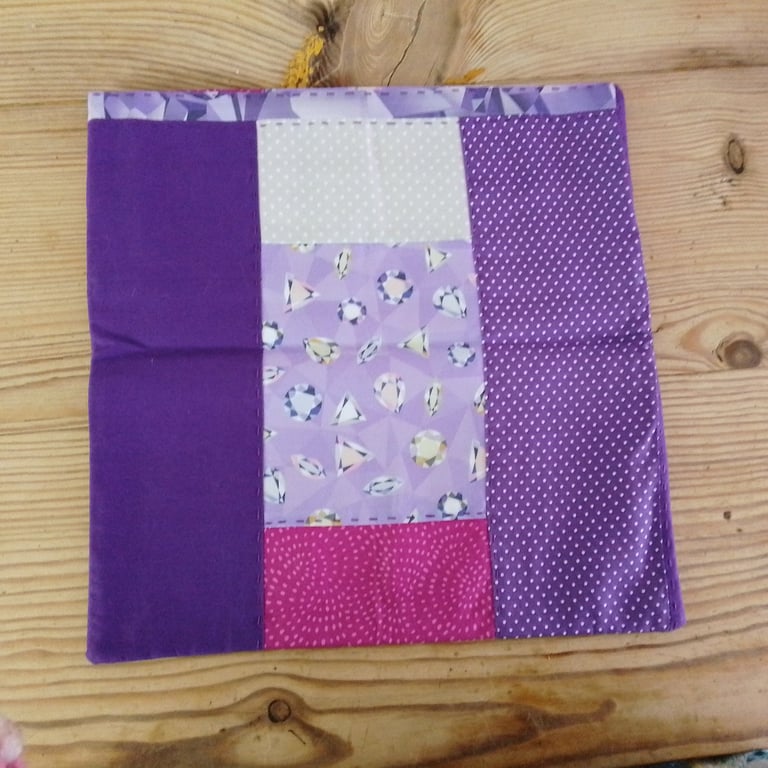 Cushion cover handmade in a purple fabric theme with envelope closure.