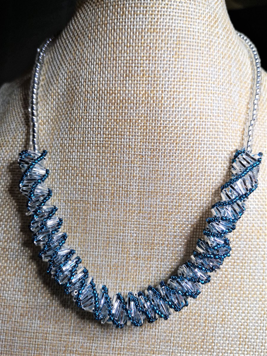 Spiral necklace with silver and teal beads