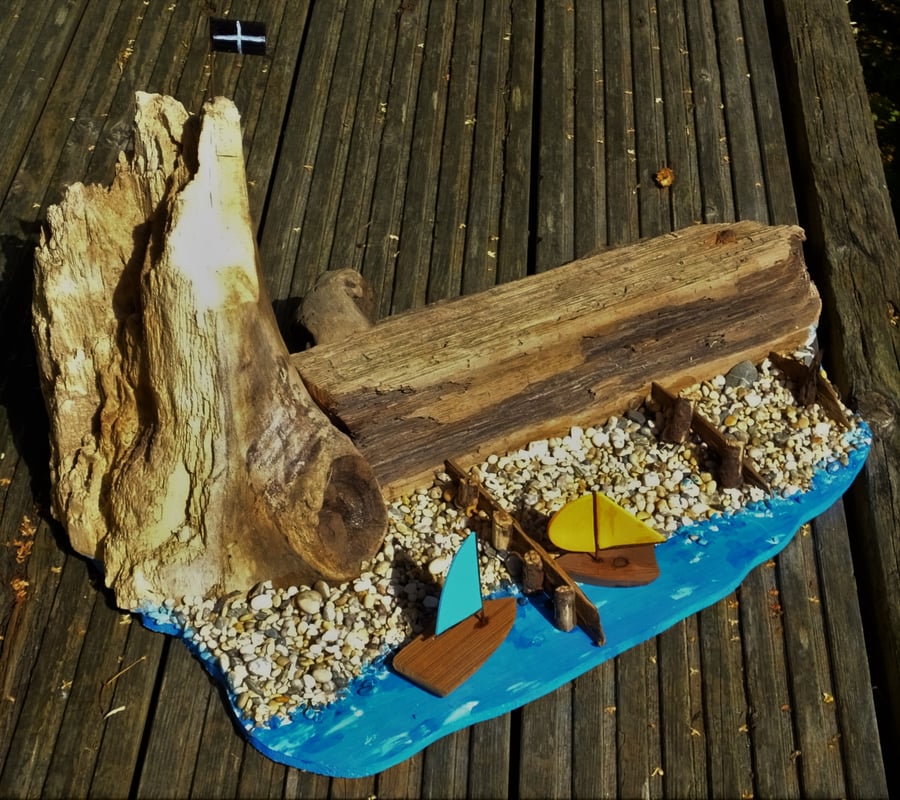 Harbour wall breakwater & cave rugged cliff pebble beach with groynes surfboard