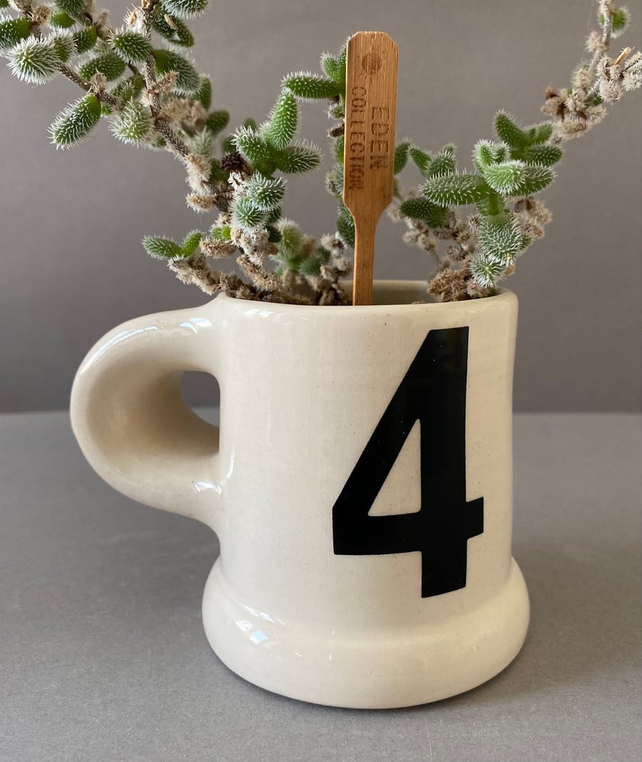 4. Number four ceramic handmade cup.