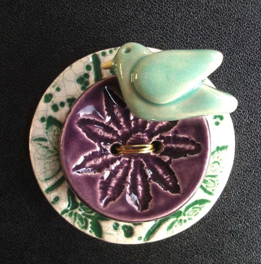 Ceramic bird on a button brooch
