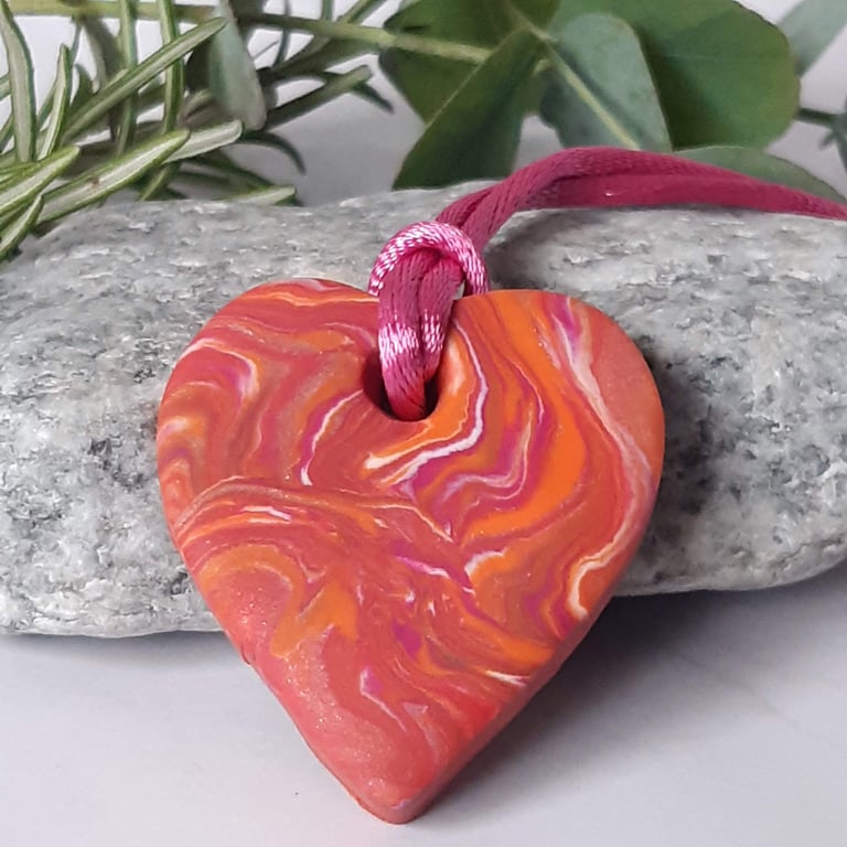 Orange and hot pink heart shaped polymer clay pendant