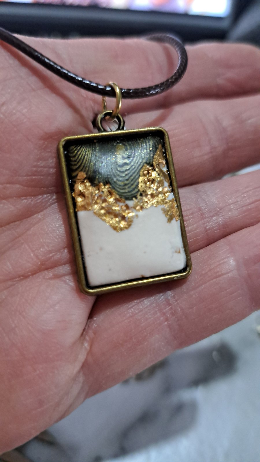 Rope necklace with a polymer clay filled bezel. Gold leaf, black and white