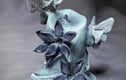 Unlit - a series of candle sculptures with moths, ivy and flowers