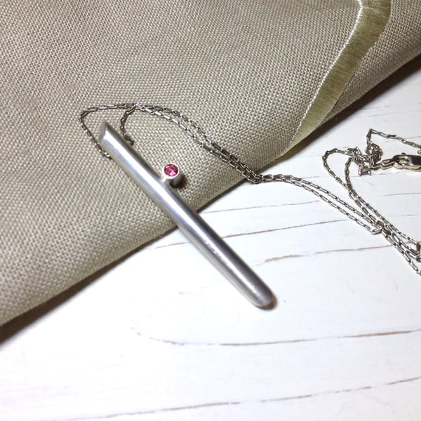 Sterling Silver Tube Pendant Necklace set with a Pink Topaz.