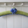 Padded ladies coat hanger with hand knitted crocus flowers