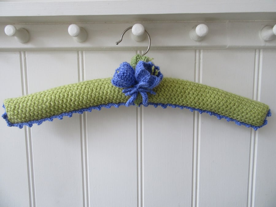 Padded ladies coat hanger with hand knitted crocus flowers