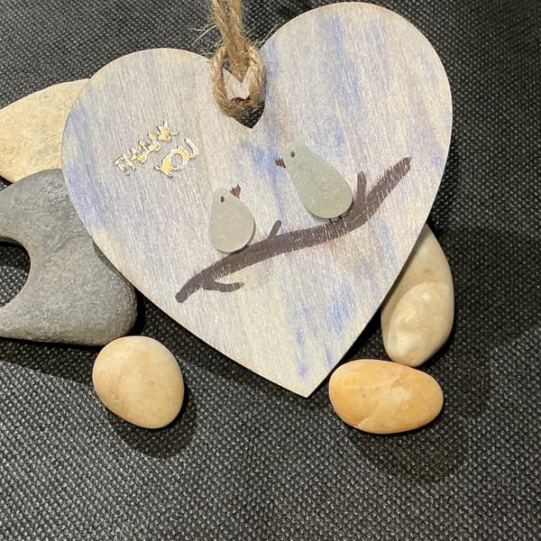 Wooden heart with 'thank you' sentiment and birds on a branch.