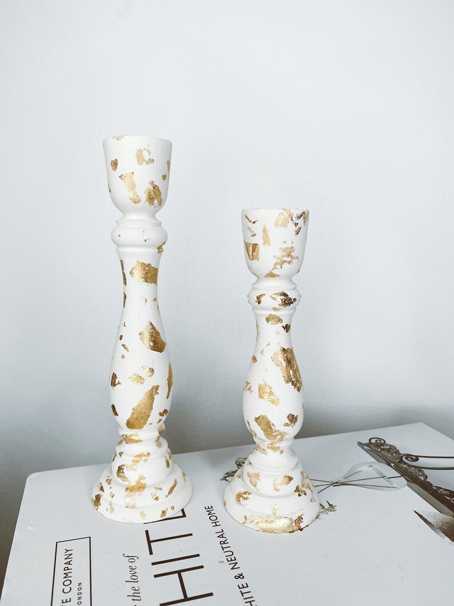 A Pair Of Gold Leaf Candle Sticks