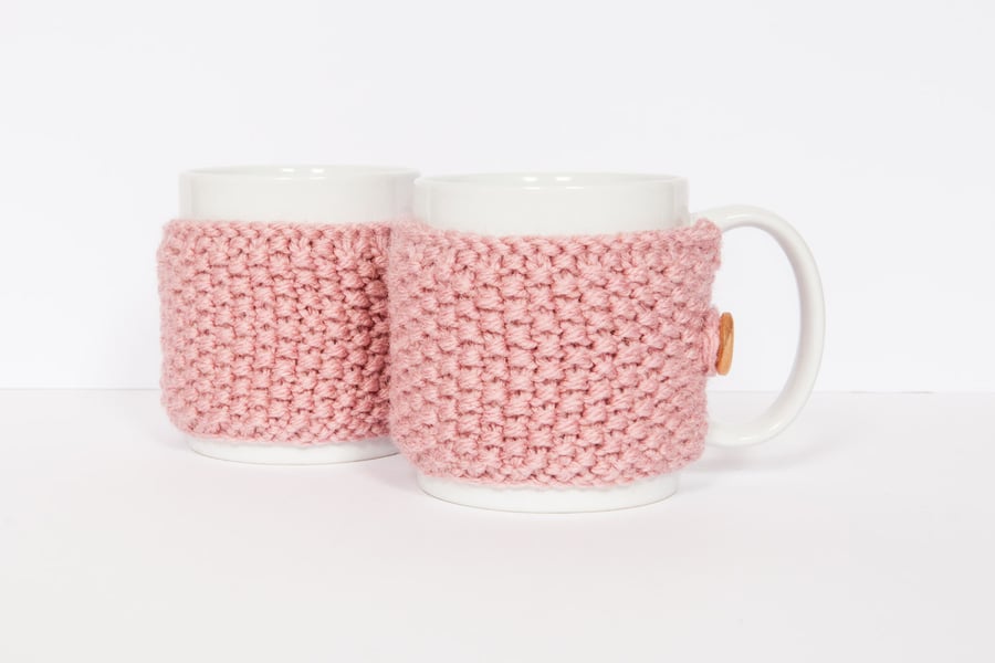 Pair of knitted mug cosies, cup cosy, coffee cosy in Pink. Coffee mug cosy