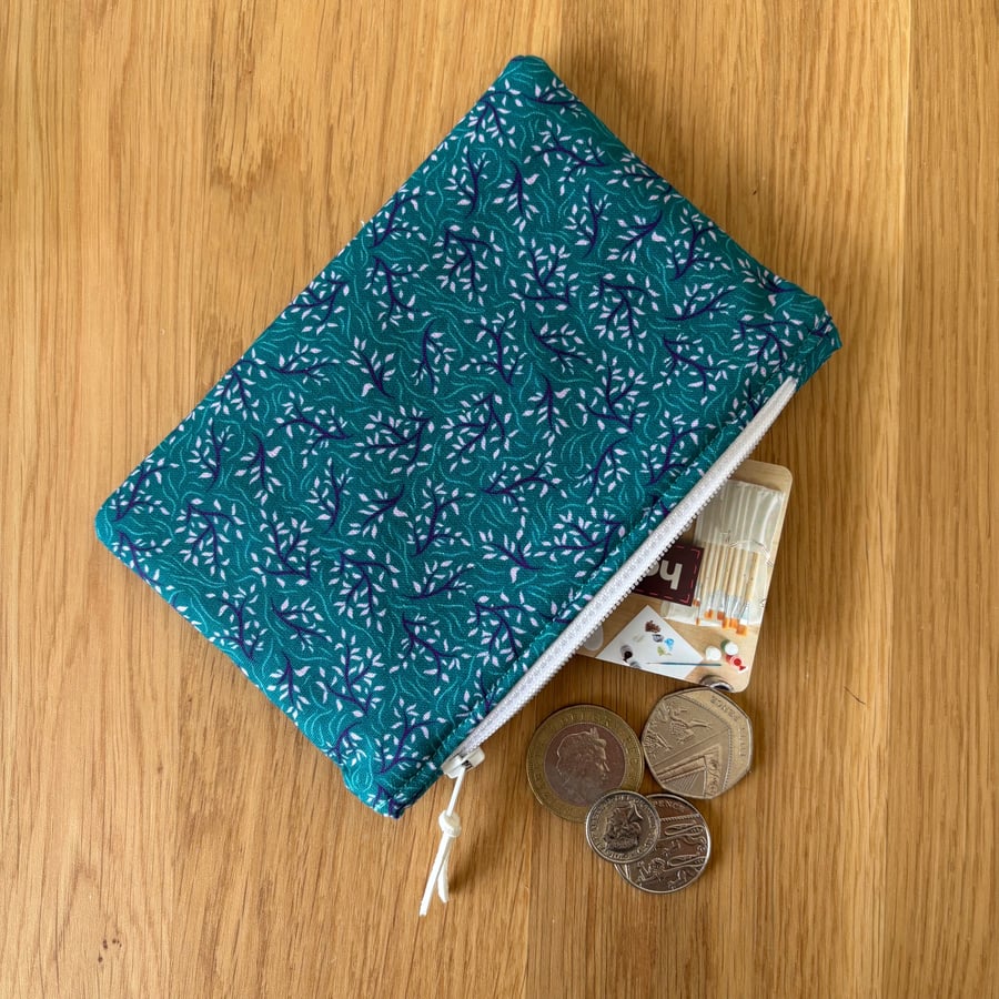 Small zipped fabric coin purse, pouch, in teal green and lilac print.